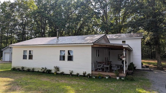 rear view of property featuring a lawn