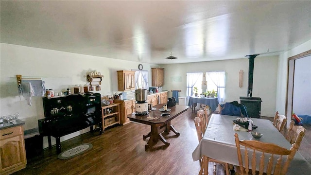 dining space featuring a wood stove and hardwood / wood-style floors