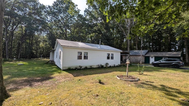 view of side of property with a yard