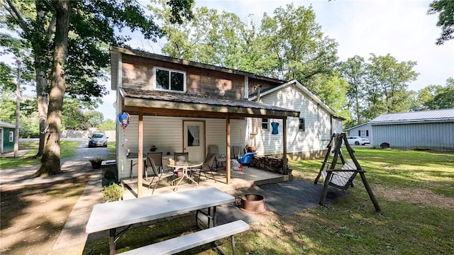 back of property with a patio and a yard