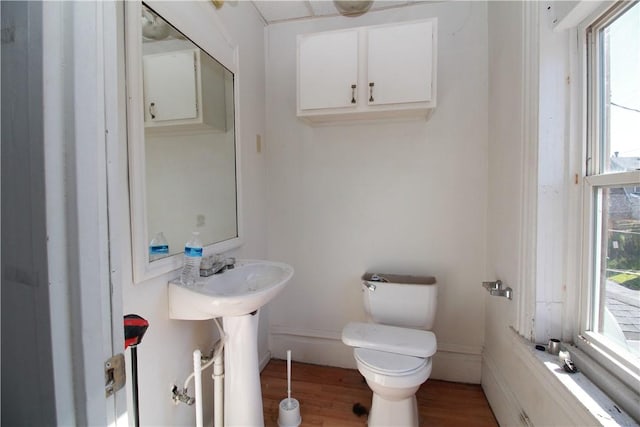 814 Etna St, Mckees Rocks, PA 15136 - half bath featuring toilet, plenty of natural light, and wood finished floors