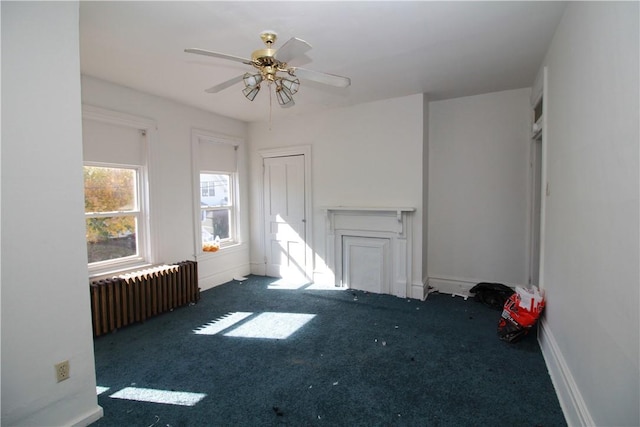 814 Etna St, Mckees Rocks, PA 15136 - unfurnished living room with radiator heating unit, carpet floors, ceiling fan, and baseboards