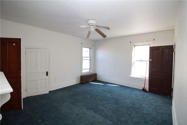814 Etna St, Mckees Rocks, PA 15136 - carpeted empty room featuring radiator heating unit, healthy amount of natural light, ceiling fan, and baseboards