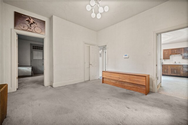 interior space with an inviting chandelier and light carpet