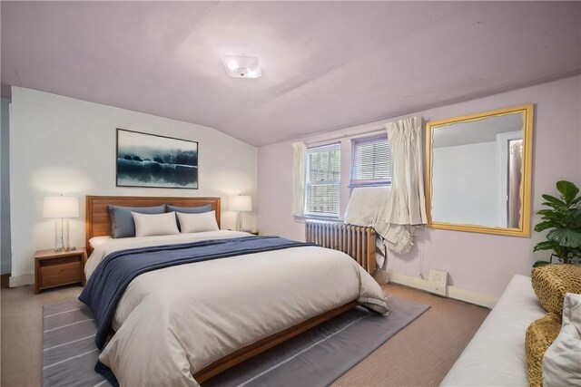 bedroom featuring carpet floors, radiator heating unit, and vaulted ceiling