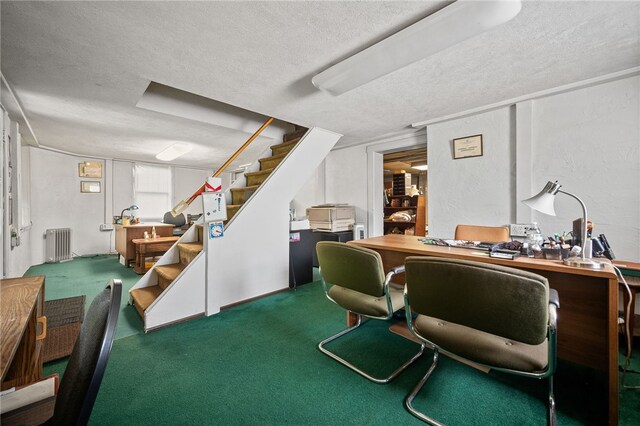 office area with carpet, radiator, and a textured ceiling