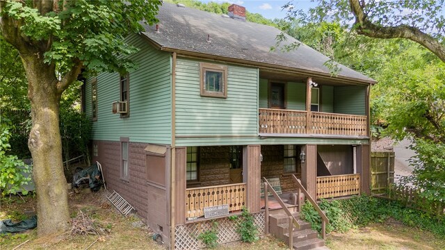 view of front of house featuring a balcony