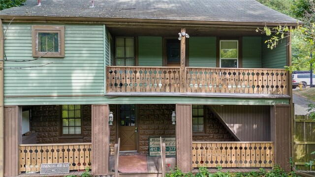 view of front of house featuring a balcony