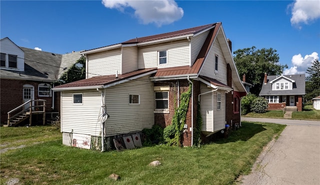 rear view of property featuring a yard