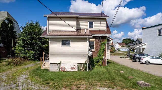 rear view of house with a yard