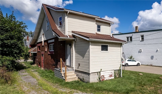 view of home's exterior featuring a lawn