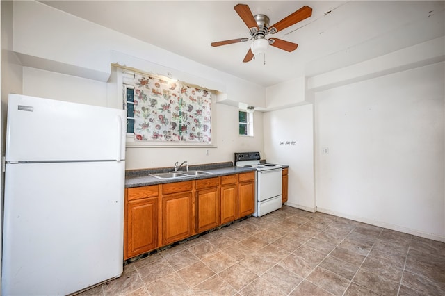 kitchen with light tile patterned floors, white appliances, sink, and ceiling fan