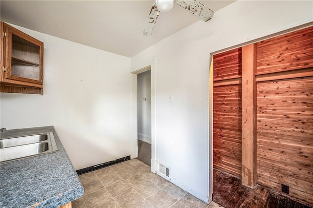 kitchen with sink, light tile patterned floors, and ceiling fan