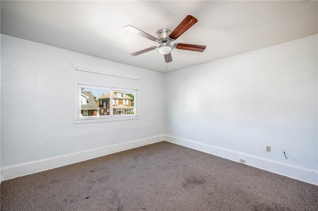 carpeted spare room featuring ceiling fan