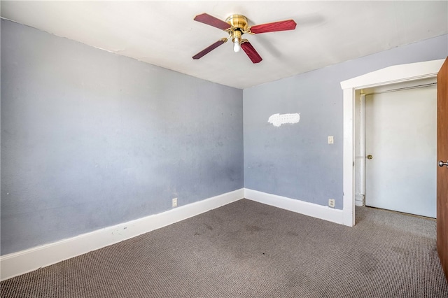 unfurnished room with ceiling fan and carpet flooring