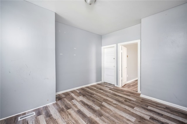 spare room with hardwood / wood-style floors