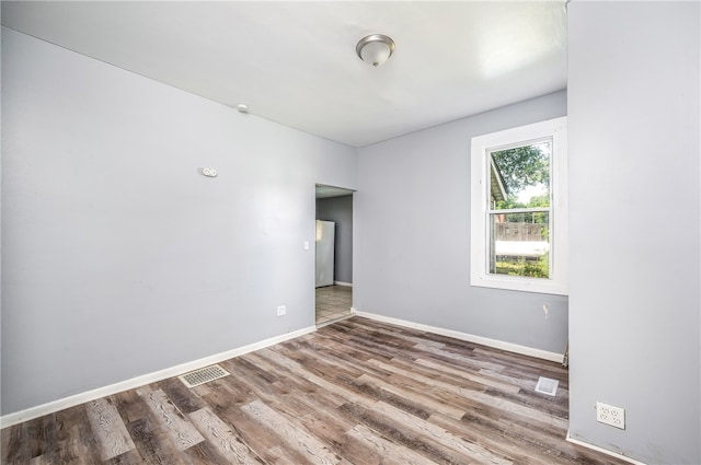 empty room featuring hardwood / wood-style flooring