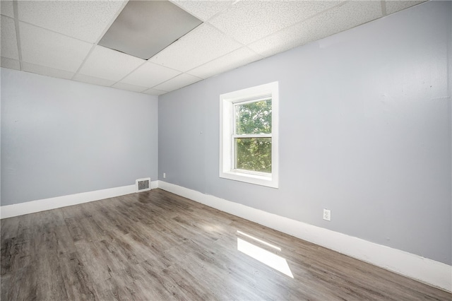 unfurnished room featuring a paneled ceiling and wood-type flooring