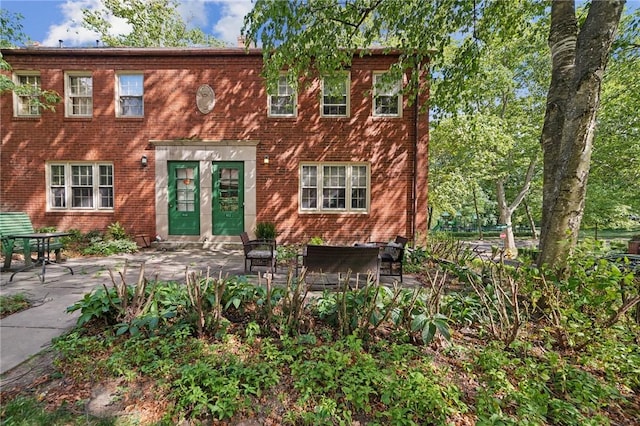 view of front of house with french doors and a patio