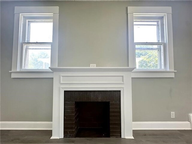 interior details with hardwood / wood-style flooring and a brick fireplace