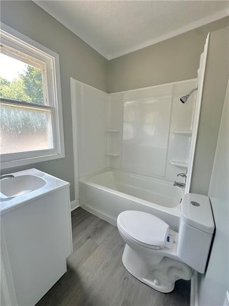 full bathroom with vanity, shower / bathtub combination, toilet, and wood-type flooring