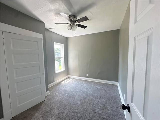 unfurnished bedroom featuring ceiling fan, carpet, and a textured ceiling