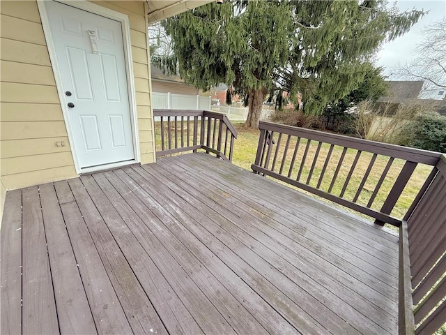 wooden deck with a lawn