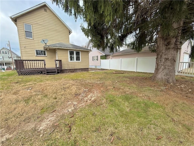 back of house featuring a yard and a deck