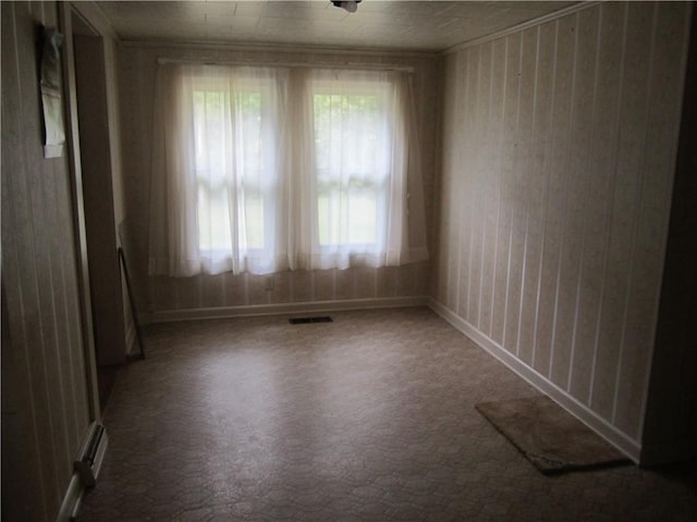 unfurnished room featuring crown molding, visible vents, and a healthy amount of sunlight