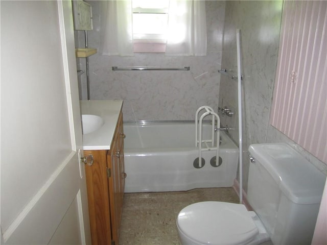 bathroom featuring vanity, toilet, and a tub