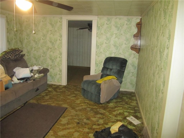 sitting room with carpet floors, wallpapered walls, and baseboards