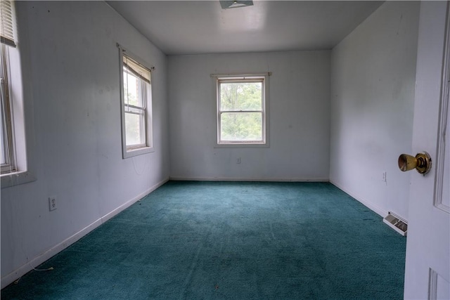 spare room featuring carpet flooring and plenty of natural light