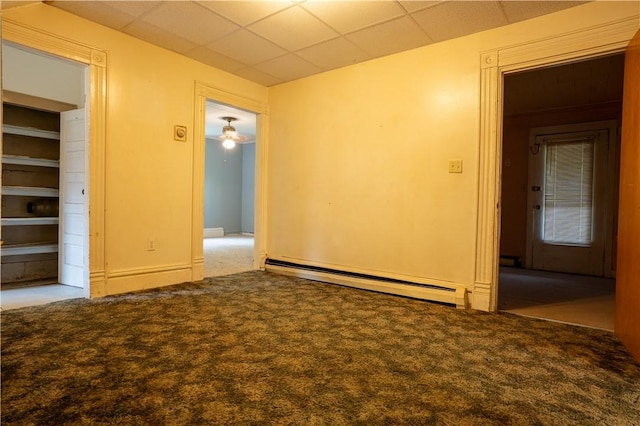 carpeted empty room featuring baseboard heating