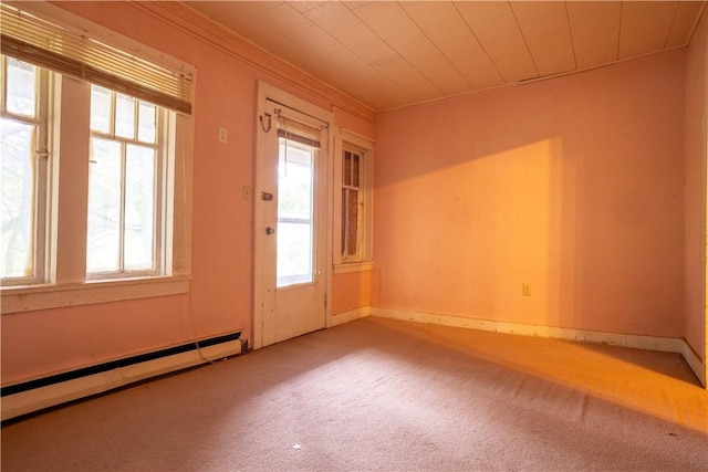 doorway to outside with a baseboard heating unit and carpet flooring