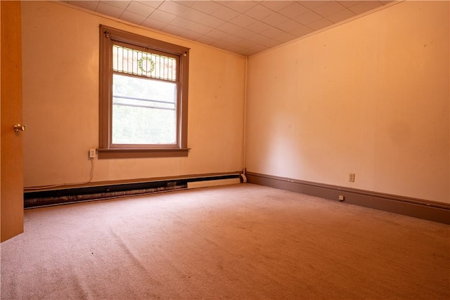 unfurnished room featuring carpet and a baseboard heating unit