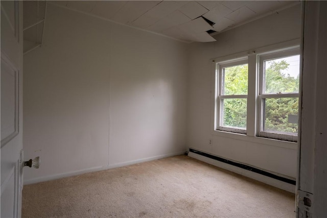 carpeted empty room with a baseboard heating unit