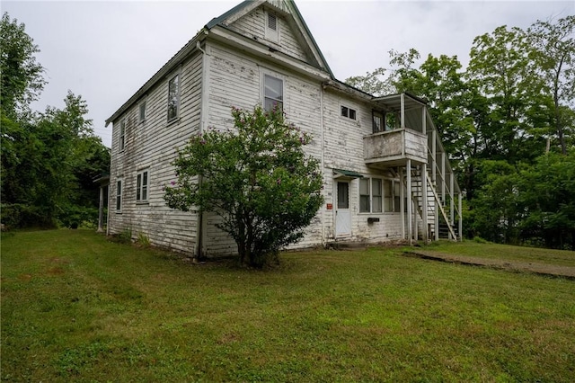 view of side of property with a yard