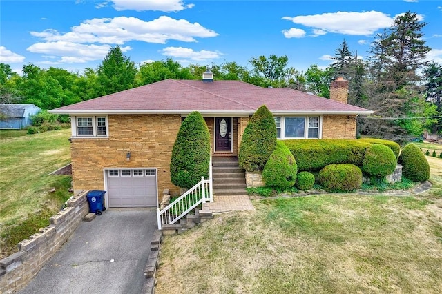 view of front of house with a front yard and a garage