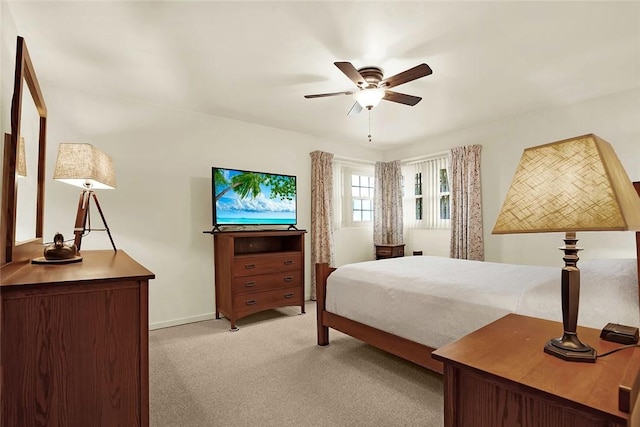 bedroom with light carpet and ceiling fan