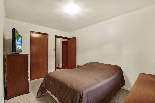 bedroom featuring light carpet