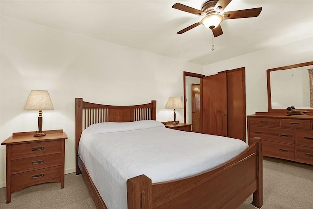 carpeted bedroom featuring a closet and ceiling fan