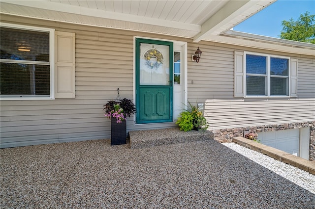 view of exterior entry with a garage