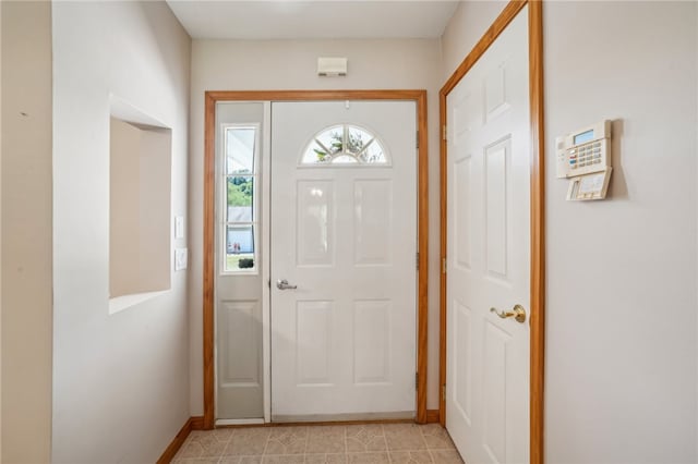 entryway with light tile patterned flooring