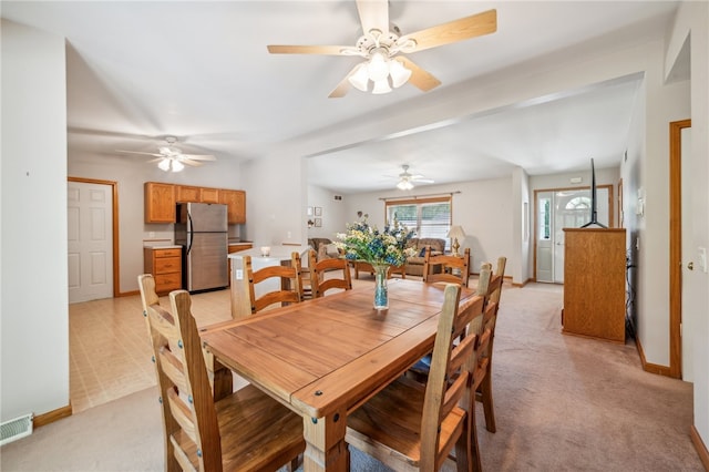 carpeted dining area featuring ceiling fan