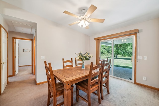 dining space with light colored carpet and ceiling fan