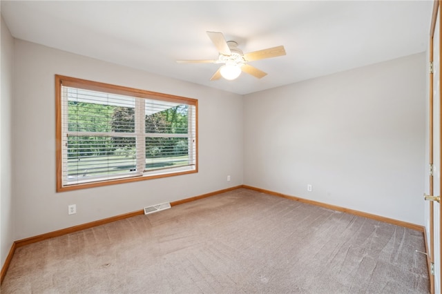 spare room featuring carpet flooring and ceiling fan