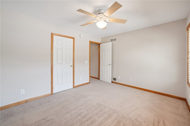 unfurnished bedroom featuring light carpet and ceiling fan