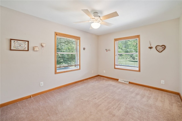 carpeted empty room featuring ceiling fan