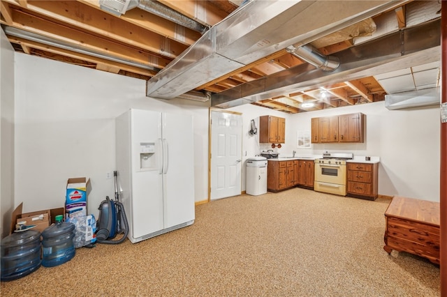 basement with sink and white fridge with ice dispenser