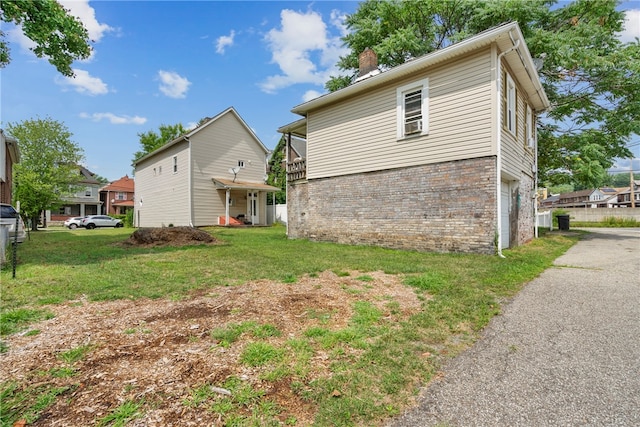 rear view of house featuring a yard